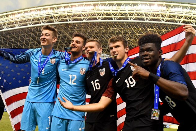 US footballers celebrate with their medals after winning the U-20 Concacaf final football match against Honduras at the National stadium in San Jose on March 5, 2017. / AFP PHOTO / EZEQUIEL BECERRA        (Photo credit should read EZEQUIEL BECERRA/AFP/Getty Images)