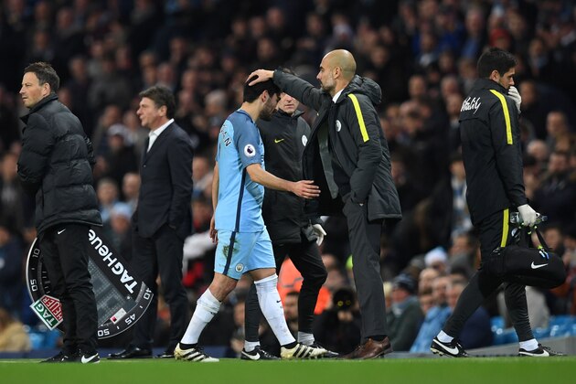 Manchester City's Spanish manager Pep Guardiola (CR) greets Manchester City's German midfielder Ilkay Gundogan (CL) as hee is substituted during the English Premier League football match between Manchester City and Watford at the Etihad Stadium in Manchester, north west England, on December 14, 2016. / AFP / Paul ELLIS / RESTRICTED TO EDITORIAL USE. No use with unauthorized audio, video, data, fixture lists, club/league logos or 'live' services. Online in-match use limited to 75 images, no video emulation. No use in betting, games or single club/league/player publications.  /         (Photo credit should read PAUL ELLIS/AFP/Getty Images)