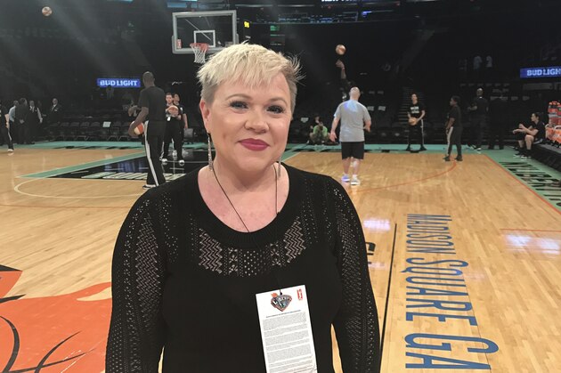 Holly Rowe stands on the court at Madison Square Garden in New York before a WNBA basketball game between the New York Liberty and the Minnesota Lynx, Thursday, May 18, 2017. Rowe was back on the sidelines for her first WNBA game of the season Thursday night. Dashing for interviews with coaches between quarters or talking to NBA Commissioner Adam Silver, who attend the game, Rowe was in her element. It was a welcome reprieve for her from her bout with melanoma which has recurred and spread. Earlier in the day, ESPN announced that it had re-signed Rowe to a multiyear contract extension. She was worried she be one of the people ESPN let go last month. (AP Photo/Doug Feinberg)