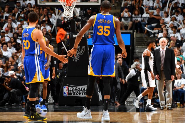 SAN ANTONIO, TX - MAY 20: Kevin Durant #35 and Stephen Curry #30 of the Golden State Warriors high five each other during the game against the San Antonio Spurs during Game Three of the Western Conference Finals of the 2017 NBA Playoffs on May 20, 2017 at the AT&T Center in San Antonio, Texas. NOTE TO USER: User expressly acknowledges and agrees that, by downloading and or using this photograph, user is consenting to the terms and conditions of the Getty Images License Agreement. Mandatory Copyright Notice: Copyright 2017 NBAE (Photos by Jesse D. Garrabrant/NBAE via Getty Images)