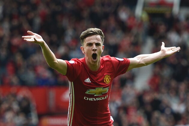 Manchester United's English midfielder Josh Harrop celebrates scoring the opening goal during the English Premier League football match between Manchester United and Cyrstal Palace at Old Trafford in Manchester, north west England, on May 21, 2017. / AFP PHOTO / Oli SCARFF / RESTRICTED TO EDITORIAL USE. No use with unauthorized audio, video, data, fixture lists, club/league logos or 'live' services. Online in-match use limited to 75 images, no video emulation. No use in betting, games or single club/league/player publications.  /         (Photo credit should read OLI SCARFF/AFP/Getty Images)