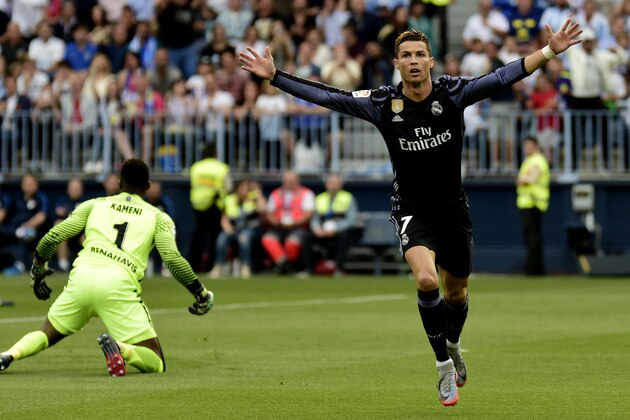 Real Madrid's Portuguese forward Cristiano Ronaldo celebrates after scoring during the Spanish league football match Malaga CF vs Real Madrid CF  at La Rosaleda stadium in Malaga on May 21, 2017. / AFP PHOTO / JOSE JORDAN        (Photo credit should read JOSE JORDAN/AFP/Getty Images)