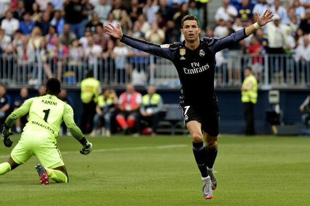 Real Madrid's Portuguese forward Cristiano Ronaldo celebrates after scoring during the Spanish league football match Malaga CF vs Real Madrid CF  at La Rosaleda stadium in Malaga on May 21, 2017. / AFP PHOTO / JOSE JORDAN        (Photo credit should read JOSE JORDAN/AFP/Getty Images)