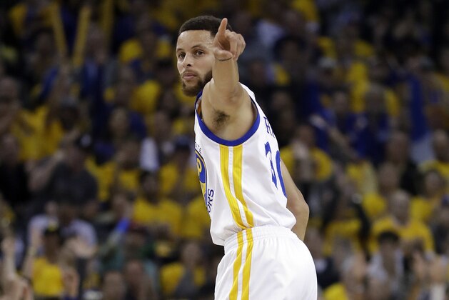 Golden State Warriors' Stephen Curry signals after scoring against the San Antonio Spurs during the first half of Game 2 of the NBA basketball Western Conference finals, Tuesday, May 16, 2017, in Oakland, Calif. (AP Photo/Marcio Jose Sanchez)