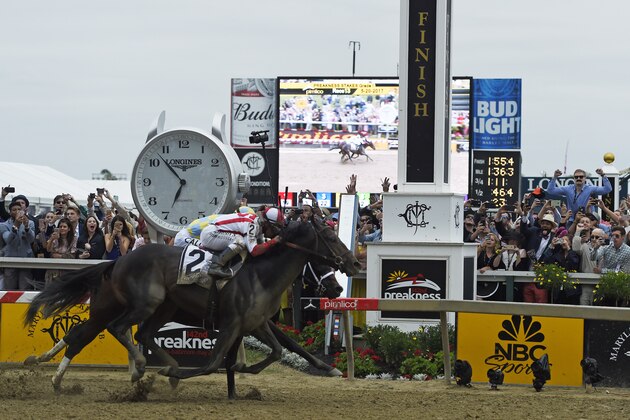 Cloud Computing (2), ridden by Javier Castellano, wins the 142nd Preakness Stakes horse race at Pimlico race course as Classic Empire with Julien Leparoux aboard takes second, Saturday, May 20, 2017, in Baltimore. NFL football player Baltimore Ravens first-round draft pick Marlon Humphrey, far left, cheers the finish. (AP Photo/Mike Stewart)