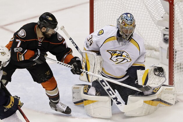 Nashville Predators goalie Pekka Rinne, right, makes a save with his glove off a shot by Anaheim Ducks center Andrew Cogliano, left, during the third period of Game 5 in the NHL hockey Stanley Cup Western Conference finals in Anaheim, Calif., Saturday, May 20, 2017. (AP Photo/Chris Carlson)