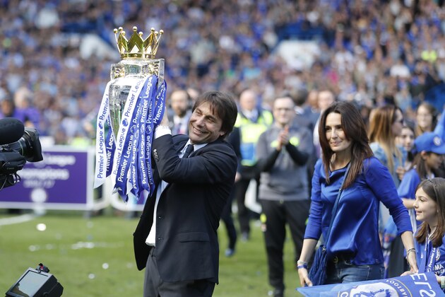 Chelsea's manager Antonio Conte holds the trophy beside his wife Elisabetta after the English Premier League soccer match between Chelsea and Sunderland at Stamford Bridge stadium in London, Sunday, May 21, 2017. (AP Photo/Frank Augstein)