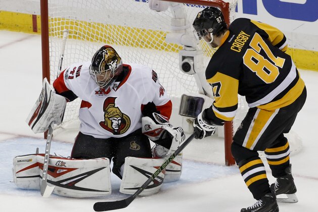 Pittsburgh Penguins' Sidney Crosby (87) scores on Ottawa Senators goalie Craig Anderson (41) during the first period of Game 5 in the NHL hockey Stanley Cup Eastern Conference finals, Sunday, May 21, 2017, in Pittsburgh. (AP Photo/Gene J.Puskar)