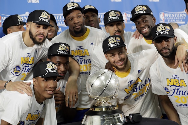 Golden State Warriors' JaVale McGee, top left, Kevin Durant, top center, Stephen Curry, center right, and Draymond Green, top right, join the rest of their team as they pose with the trophy after their 129-115 win over the San Antonio Spurs in Game 4 of the NBA basketball Western Conference finals, Monday, May 22, 2017, in San Antonio. (AP Photo/Eric Gay)