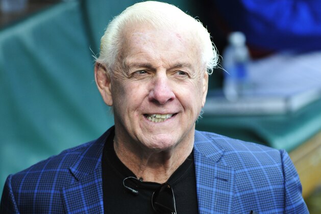 CHICAGO, IL - MAY 01: Former WWE champion Ric Flair gets ready to throw out the ceremonial first pitch before the game between the Chicago Cubs and the Atlanta Braves on May 1, 2016 at Wrigley Field in Chicago, Illinois.  (Photo by David Banks/Getty Images)