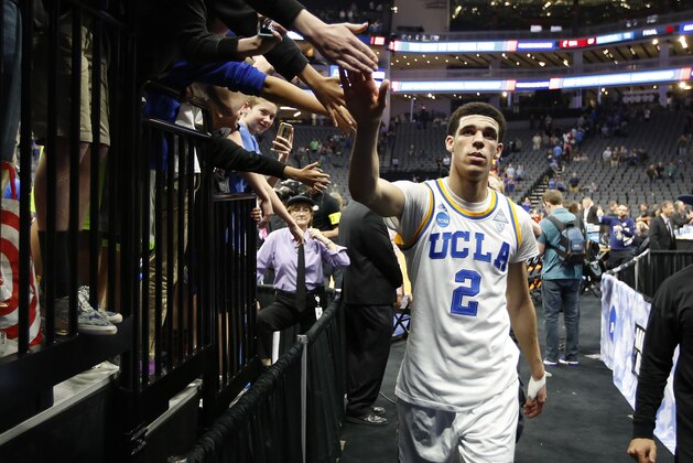 UCLA Bruins guard Lonzo Ball slaps hands as he walks to the locker room after UCLA beat Cincinnati 79-67 in a second-round game of the men's NCAA college basketball tournament in Sacramento, Calif., Sunday, March 19, 2017. (AP Photo/Rich Pedroncelli)