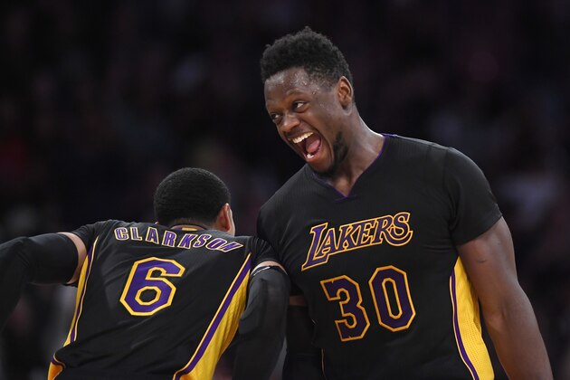 Los Angeles Lakers forward Julius Randle, right, celebrates with guard Jordan Clarkson during the second half of an NBA basketball game, Friday, March 24, 2017, in Los Angeles. The Lakers won 130-119 in overtime. (AP Photo/Mark J. Terrill)