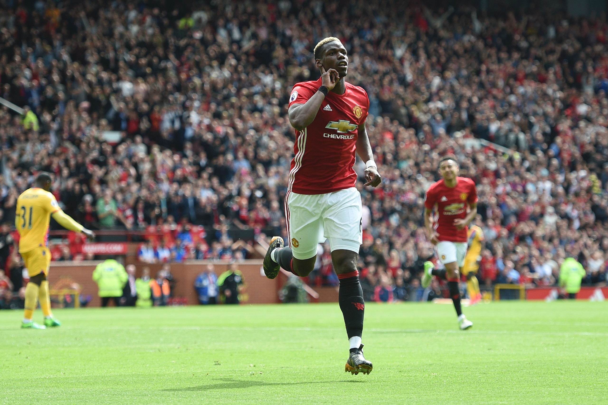 Manchester United's French midfielder Paul Pogba celebrates scoring their second goal during the English Premier League football match between Manchester United and Cyrstal Palace at Old Trafford in Manchester, north west England, on May 21, 2017. / AFP PHOTO / Oli SCARFF / RESTRICTED TO EDITORIAL USE. No use with unauthorized audio, video, data, fixture lists, club/league logos or 'live' services. Online in-match use limited to 75 images, no video emulation. No use in betting, games or single club/league/player publications.  /         (Photo credit should read OLI SCARFF/AFP/Getty Images)
