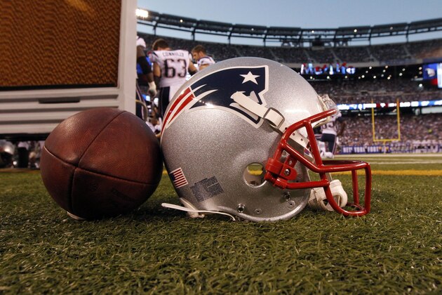 A New England Patriots helmet sits on the sideline next to a football during the first half of a preseason NFL football game between the New York Giants and the New England Patriots Wednesday, Aug. 29, 2012, in East Rutherford, N.J. (AP Photo/Julio Cortez)