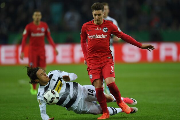 Frankfurt's Uruguayan defender Guillermo Varela and Moenchengladbach's midfielder Marvin Schulz vie for the ball during the German Cup DFB Pokal semifinal football match between Borussia Moenchengladbach and Eintracht Frankfurt in Moenchengladbach, western Germany, on April 25, 2017. / AFP PHOTO / PATRIK STOLLARZ / RESTRICTIONS: ACCORDING TO DFB RULES IMAGE SEQUENCES TO SIMULATE VIDEO IS NOT ALLOWED DURING MATCH TIME. MOBILE (MMS) USE IS NOT ALLOWED DURING AND FOR FURTHER TWO HOURS AFTER THE MATCH. == RESTRICTED TO EDITORIAL USE == FOR MORE INFORMATION CONTACT DFB DIRECTLY AT +49 69 67880

 /         (Photo credit should read PATRIK STOLLARZ/AFP/Getty Images)