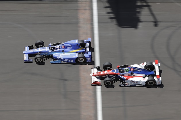 Scott Dixon, left, of New Zealand, and Conor Daly drive across the Yard of Brick during practice for the Indianapolis 500 IndyCar auto race at Indianapolis Motor Speedway, Monday, May 22, 2017, in Indianapolis. (AP Photo/Darron Cummings)