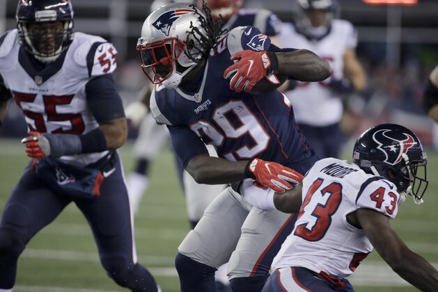 New England Patriots running back LeGarrette Blount (29) shakes an attempted tackle by Houston Texans defensive back Corey Moore (43) during the second half of an NFL divisional playoff football game, Saturday, Jan. 14, 2017, in Foxborough, Mass. (AP Photo/Steven Senne)