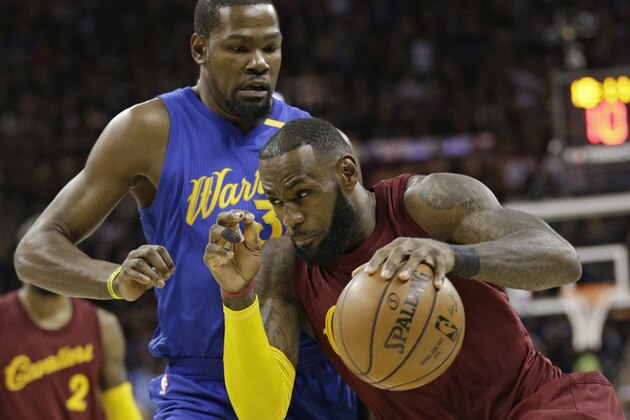 FILE - In this Dec. 25, 2016, file photo, Cleveland Cavaliers' LeBron James drives against Golden State Warriors' Kevin Durant during an NBA basketball game in Cleveland. Now, as James, Durant and their teammates wait on the next opponent for the respective conference finals, the world is watching as they move their unblemished, 8-0 teams ever closer to an anticipated Cavs-Warriors rematch that might finally come to fruition at last in a matter of weeks. (AP Photo/Tony Dejak, File)