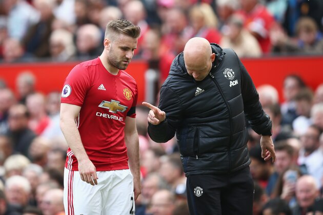 MANCHESTER, ENGLAND - APRIL 30: Luke Shaw of Manchester United speaks to Carlos Lalin, Manchester United coach after he is forced off with a injury during the Premier League match between Manchester United and Swansea City at Old Trafford on April 30, 2017 in Manchester, England.  (Photo by Jan Kruger/Getty Images)