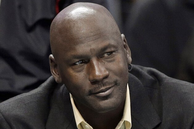FILE - This is an April 16, 2014, file photo showing Charlotte Bobcats owner Michael Jordan watching during the first half of an NBA basketball game between the Bobcats and the Chicago Bulls in Charlotte, N.C. Michael Jordan and two other NBA owners have joined Forbes’ annual list of the world’s billionaires. Forbes said Monday, March 2, 2015, that Jordan’s net worth is estimated at $1 billion, thanks to his well-timed investment in the Charlotte Hornets. (AP Photo/Chuck Burton, File)