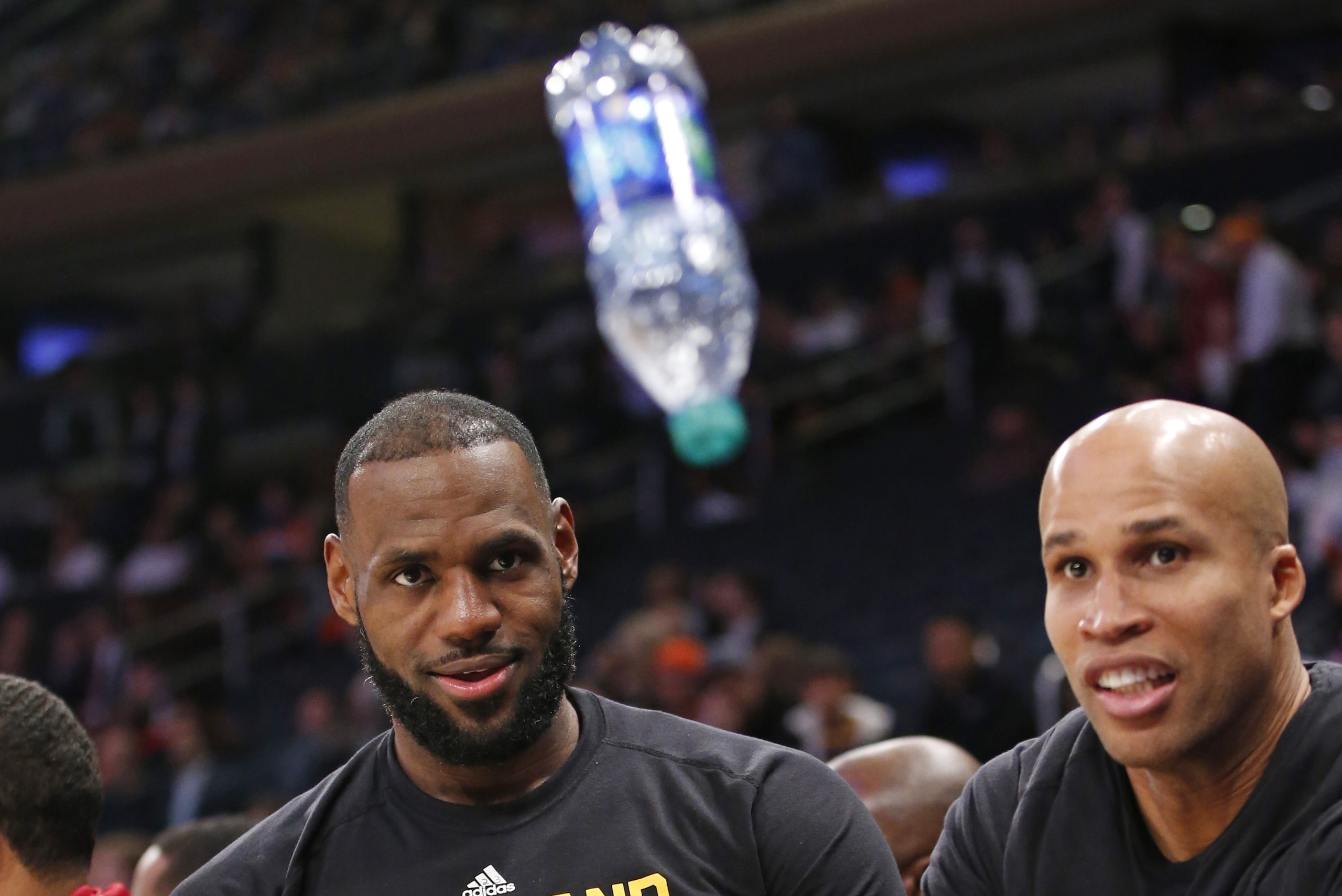 Cleveland Cavaliers forward LeBron James, left, and Cavaliers forward Richard Jefferson entertain themselves by flipping a water bottle trying to get it to land on it's flat bottom during the fourth quarter of an NBA basketball game against the New York Knicks at Madison Square Garden in New York, Wednesday, Dec. 7, 2016. The Cavaliers defeated the Knicks 126-94, and most starters left the game for the bench at the end of the fourth quarter. (AP Photo/Kathy Willens)