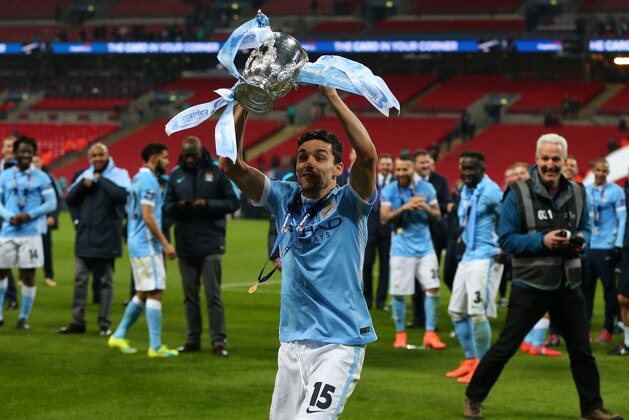 LONDON, ENGLAND - FEBRUARY 28 :  Jesus Navas of Manchester City celebrates with the trophy after the Capital One Cup Final match between Liverpool and Manchester City at Wembley Stadium on February 28, 2016 in London, England.  (Photo by Catherine Ivill - AMA/Getty Images)