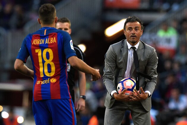 Barcelona's coach Luis Enrique (R) gives a ball to Barcelona's defender Jordi Alba during the Spanish league football match FC Barcelona vs SD Eibar at the Camp Nou stadium in Barcelona on May 21, 2017. / AFP PHOTO / LLUIS GENE        (Photo credit should read LLUIS GENE/AFP/Getty Images)