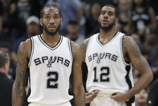 San Antonio Spurs forward Kawhi Leonard (2) and forward LaMarcus Aldridge (12) wait for play to resume during the second half of an NBA basketball game, Tuesday, Nov. 29, 2016, in San Antonio. Orlando won 95-83. (AP Photo/Eric Gay)