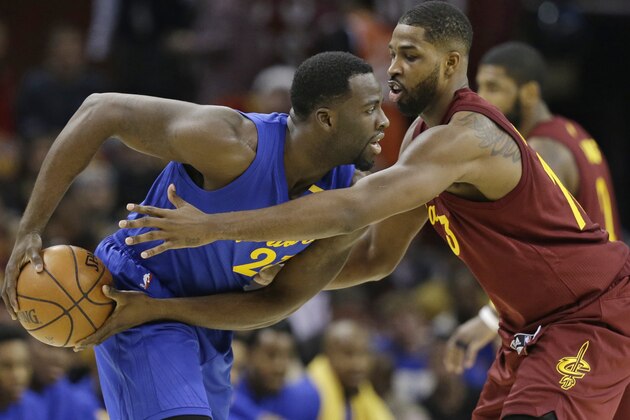 Cleveland Cavaliers' Tristan Thompson, right, puts pressure on Golden State Warriors' Draymond Green in the first half of an NBA basketball game, Sunday, Dec. 25, 2016, in Cleveland. (AP Photo/Tony Dejak)