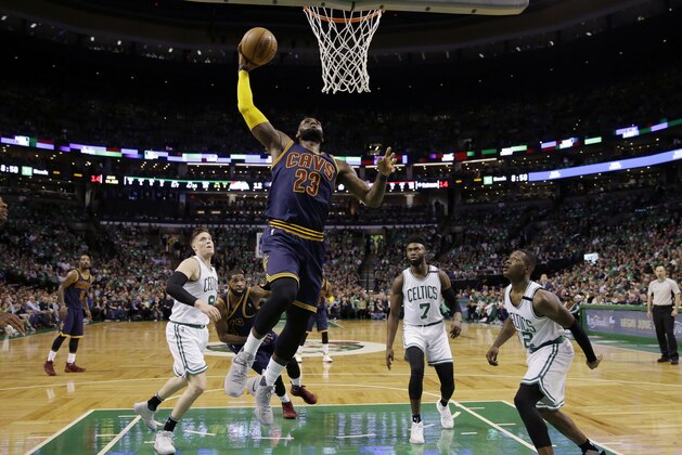 Cleveland Cavaliers forward LeBron James (23) soars to the basket over Boston Celtics forward Jonas Jerebko (8) forward Jaylen Brown (7) and guard Terry Rozier (12) during the first half of Game 5 of the NBA basketball Eastern Conference finals, on Thursday, May 25, 2017, in Boston. (AP Photo/Charles Krupa)