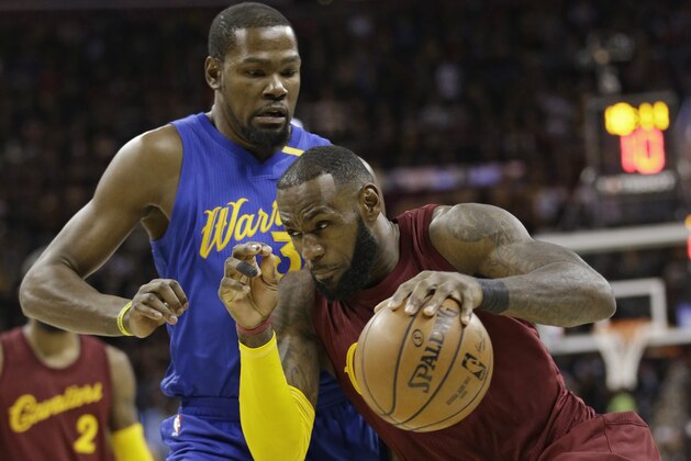 FILE - In this Dec. 25, 2016, file photo, Cleveland Cavaliers' LeBron James (23) drives past Golden State Warriors' Kevin Durant (35) in the first half of an NBA basketball game, in Cleveland. From Cleveland to Oakland, the two star-studded teams expected to rematch once more in the NBA Finals have ample time to rest up, get healthy and prepare for the next opponent. (AP Photo/Tony Dejak, File)