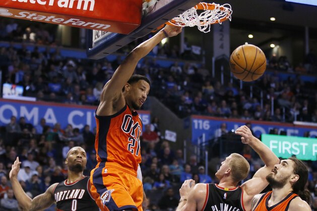 Oklahoma City Thunder forward Andre Roberson (21) dunks between Portland Trail Blazers guard Damian Lillard (0), center Mason Plumlee (24) and teammate Steven Adams, right, in the third quarter of an NBA basketball game in Oklahoma City, Sunday, Feb. 5, 2017. (AP Photo/Sue Ogrocki)