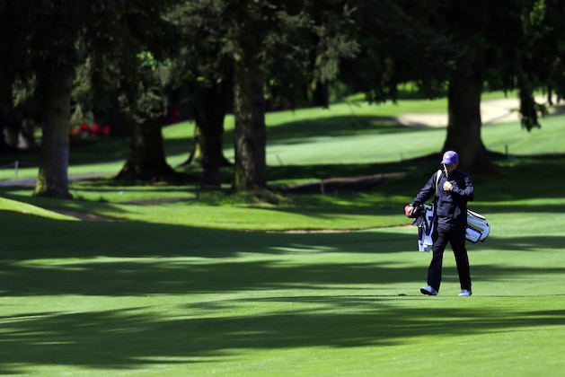 In this photo taken on Monday, May 13, 2013, University of Washington golfer Chris Williams walks down a fairway during a practice round at the Seattle Golf Club in Seattle. Williams, a senior, is currently ranked as the world's No. 1 amateur golfer. Quiet and unassuming, he will head to the NCAA championships next week in Atlanta looking for an individual title to cap his college career.  (AP Photo/Ted S. Warren)