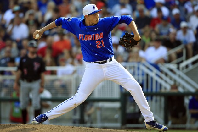 FILE - In this June 21, 2016, file photo, Florida's Alex Faedo (21) pitches against Texas Tech in the eighth inning of an NCAA men's College World Series baseball game in Omaha, Neb. The Gators have a lockdown weekend rotation with Alex Faedo, Brady Singer and Jackson Kowar. (AP Photo/Nati Harnik, File)