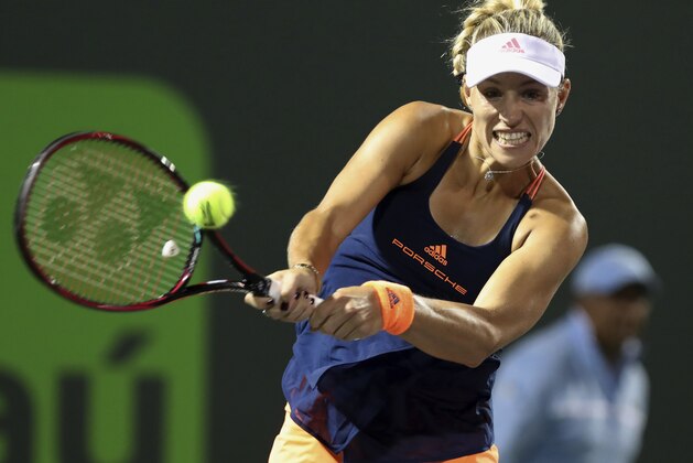 Angelique Kerber, of Germany, returns a shot against Venus Williams, of the United States, during a quarterfinal match at the Miami Open tennis tournament, Wednesday, March 29, 2017, in Key Biscayne, Fla. Williams defeated Kerber 7-5, 6-3. (AP Photo/Mario Houben)