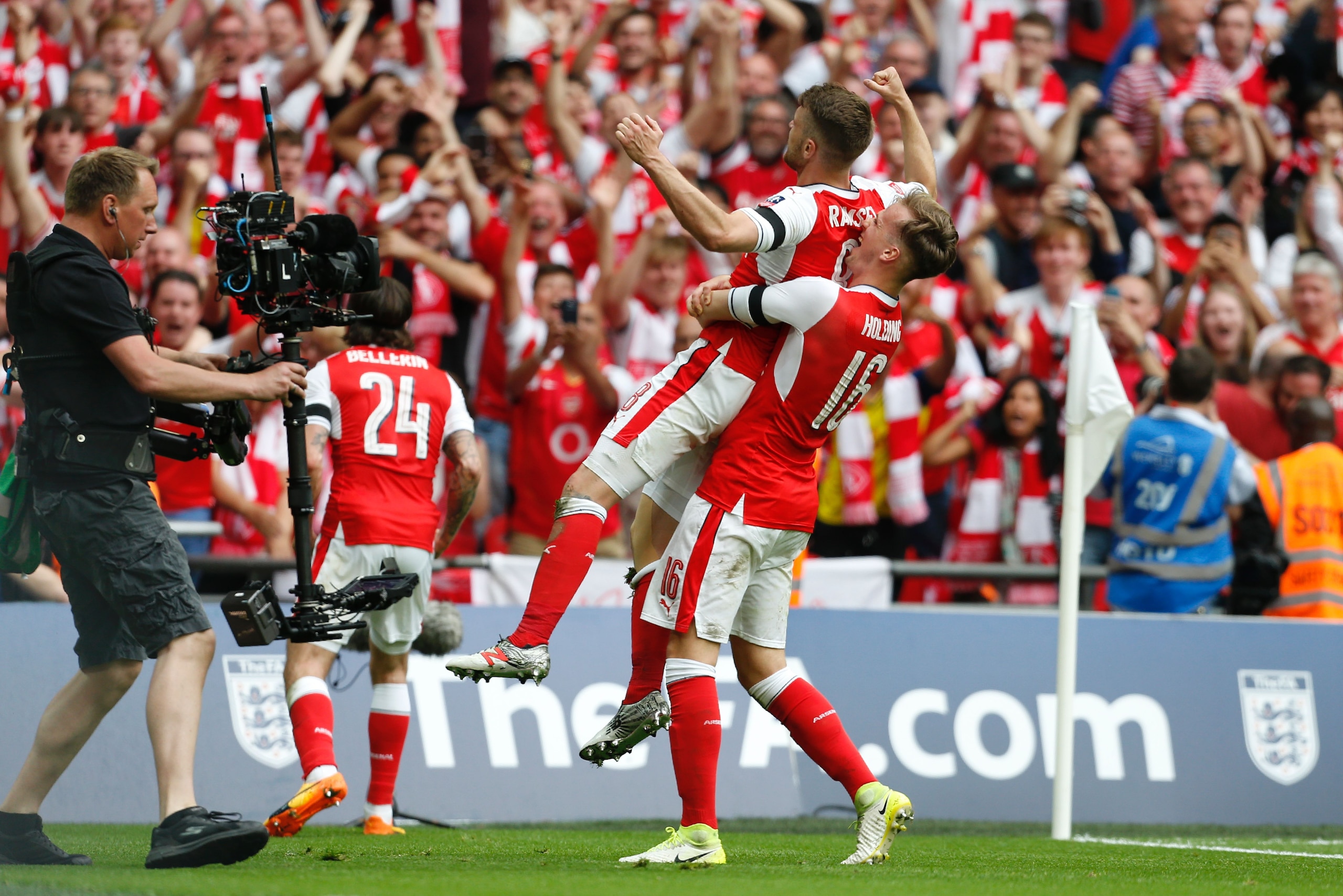 Arsenal's Welsh midfielder Aaron Ramsey (2nd R) celebrates with Arsenal's English defender Rob Holding (R) after scoring their second goal during the English FA Cup final football match between Arsenal and Chelsea at Wembley stadium in London on May 27, 2017. / AFP PHOTO / Ian KINGTON / NOT FOR MARKETING OR ADVERTISING USE / RESTRICTED TO EDITORIAL USE        (Photo credit should read IAN KINGTON/AFP/Getty Images)