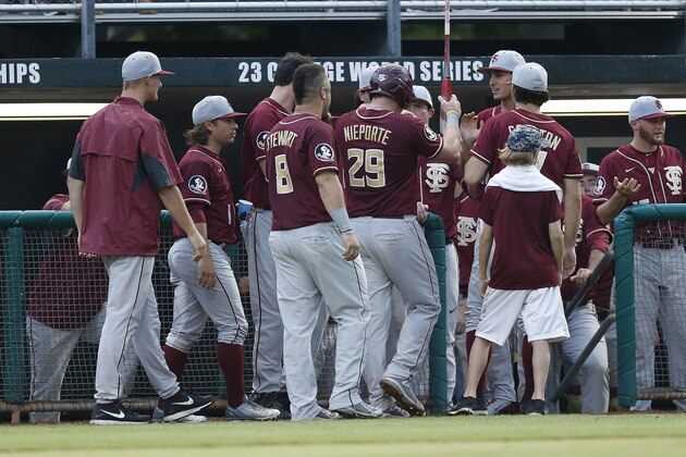 CORAL GABLES, FL - APRIL 24: Quincy Nieporte #29 is congratulated by teammates after scoring on a hit by Dylan Busby #28 (not pictured) of the Florida State Seminoles against the Miami Hurricanes on April 24, 2015 at Alex Rodriguez Park at Mark Light Field in Coral Gables, Florida. (Photo by Joel Auerbach/Getty Images)