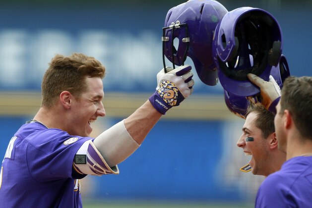 LSU's Greg Deichmann (left) celebrates with Cole Freeman (center) and Nick Coomes (right) after hitting a home run against South Carolina during the first inning of the Southeastern Conference NCAA college baseball tournament, Saturday, May 27, 2017, in Hoover, Ala. (AP Photo/Butch Dill)
