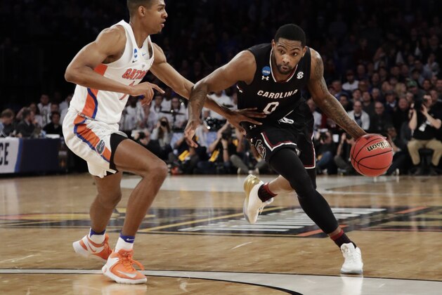 South Carolina guard Sindarius Thornwell (0) drives the ball against Florida forward Devin Robinson (1) during the first half of the East Regional championship game of the NCAA men's college basketball tournament, Sunday, March 26, 2017, in New York. (AP Photo/Frank Franklin II)