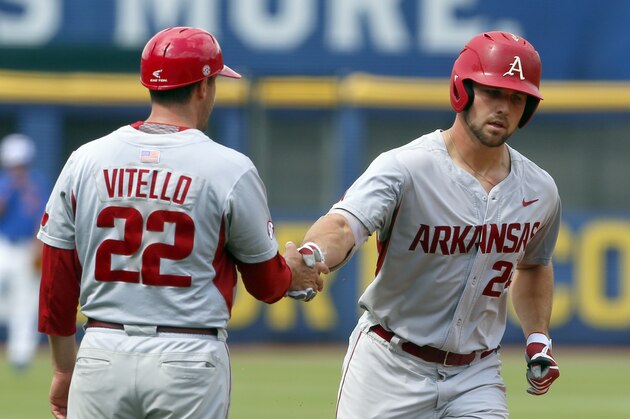 Arkansas third base coach Tony Vitello congratulates Chad Spanberger (24) as he rounds third after hitting a home run against Florida during the first inning in the Southeastern Conference NCAA college baseball tournament, Saturday, May 27, 2017, in Hoover, Ala. (AP Photo/Butch Dill)