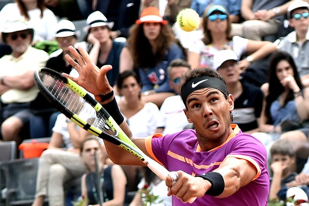 Rafael Nadal of Spain hits a return to Dominic Thiem of Austria during their quarter-final tennis match at the ATP Tennis Open tournament on May 19, 2017 at the Foro Italico in Rome.
Austria's Dominic Thiem sent Rafael Nadal crashing out of the Rome Masters with a 6-4, 6-3 quarter-final victory, ending the Spaniard's 17-match winning run. / AFP PHOTO / TIZIANA FABI        (Photo credit should read TIZIANA FABI/AFP/Getty Images)