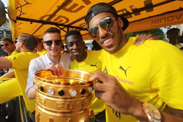 DORTMUND, GERMANY - MAY 28:  Pierre-Emerick Aubameyang (R), Ousmane Dembele (C) and Marco Reus of Borussia Dortmund lift the DFB Cup trophy as the team celebrates during a winner's parade at Borsigplatz on May 28, 2017 in Dortmund, Germany.  (Photo by Pool - Getty Images)