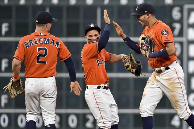 Houston Astros' Jose Altuve, center, Carlos Correa, right, and Alex Bregman (2) celebrate their win over the Baltimore Orioles in a baseball game, Friday, May 26, 2017, in Houston. (AP Photo/Eric Christian Smith)