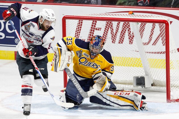 WINDSOR, ON - MAY 24: Forward Aaron Luchuk #91 of the Windsor Spitfires deflects the puck against goaltender Troy Timpano #33 of the Erie Otters on May 24, 2017 during Game 6 of the Mastercard Memorial Cup at the WFCU Centre in Windsor, Ontario, Canada. (Photo by Dennis Pajot/Getty Images)