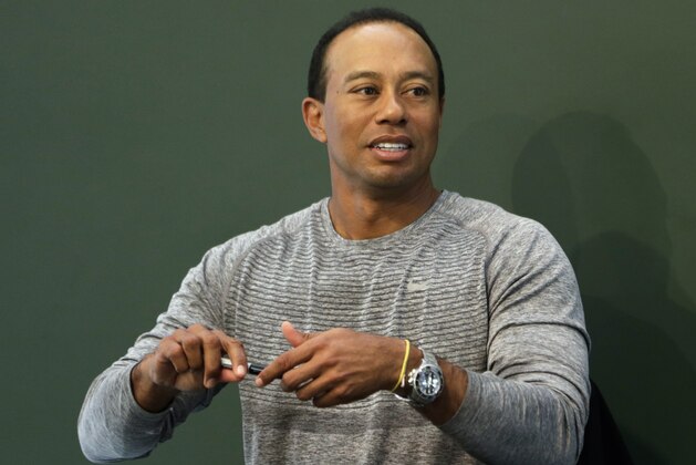 Golfer Tiger Woods prepares to sign copies of his new book at a book signing in New York, Monday, March 20, 2017. (AP Photo/Seth Wenig)