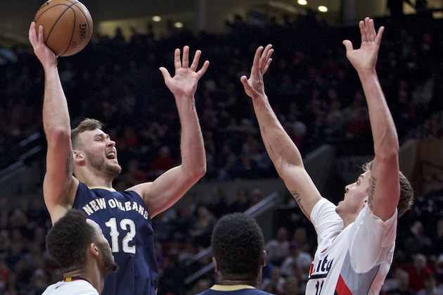 New Orleans Pelicans forward Donatas Motiejunas shoots over Portland Trail Blazers forward Meyers Leonard during the first half of an NBA basketball game in Portland, Ore., Wednesday, April 12, 2017. (AP Photo/Craig Mitchelldyer)