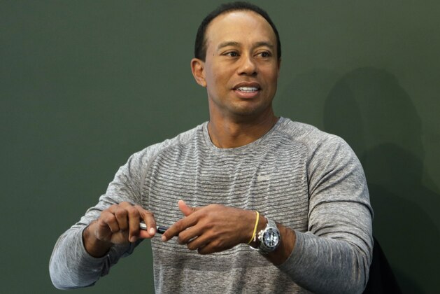 Golfer Tiger Woods prepares to sign copies of his new book at a book signing in New York, Monday, March 20, 2017. (AP Photo/Seth Wenig)