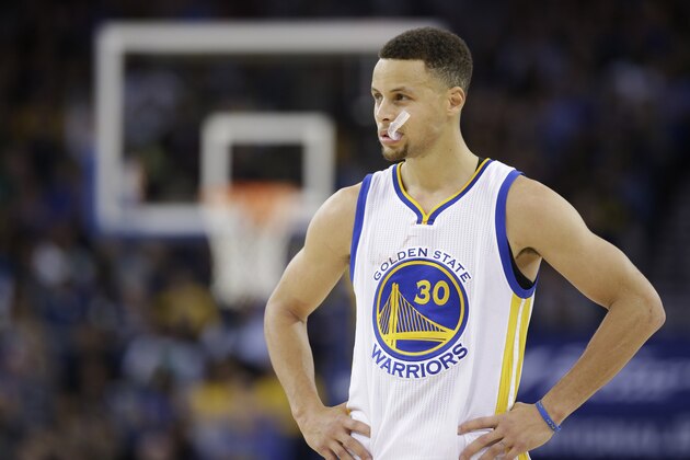 In this Friday, April 1, 2016 photo, Golden State Warriors' Steph Curry (30) pauses during an NBA basketball game against the Boston Celtics in Oakland, Calif. Though he moved on to the NBA long ago, March Madness is also Curry's world now. (AP Photo/Marcio Jose Sanchez)