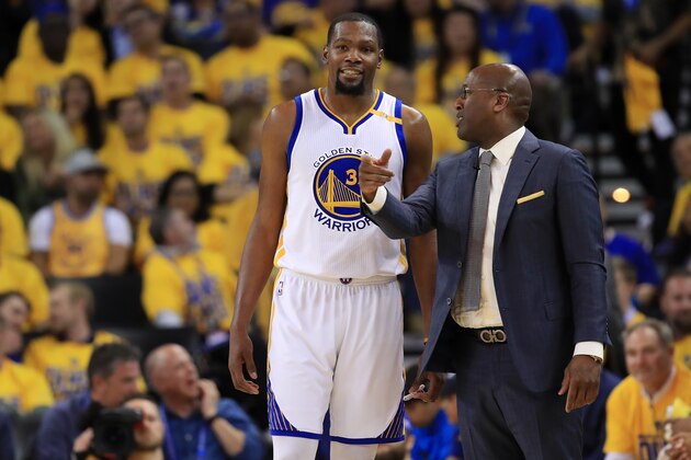 OAKLAND, CA - MAY 16:  Kevin Durant #35 of the Golden State Warriors speaks with acting head coach Mike Brown during Game Two of the NBA Western Conference Finals against the San Antonio Spurs at ORACLE Arena on May 16, 2017 in Oakland, California. NOTE TO USER: User expressly acknowledges and agrees that, by downloading and or using this photograph, User is consenting to the terms and conditions of the Getty Images License Agreement.  (Photo by Ezra Shaw/Getty Images)