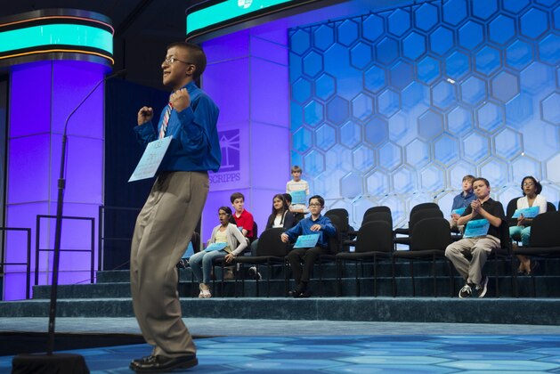 Dev Jaiswal of Louisville, Mississippi, reacts to correctly spelling his word during the semifinal round of the 88th Annual Scripps National Spelling Bee at National Harbor in Oxon Hill, Maryland, May 28, 2015. AFP PHOTO / SAUL LOEB        (Photo credit should read SAUL LOEB/AFP/Getty Images)